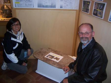 Gail and Tom Spencer examine steel plate that was located behind her cousin's, Lt. Kai-Kee's, seat
